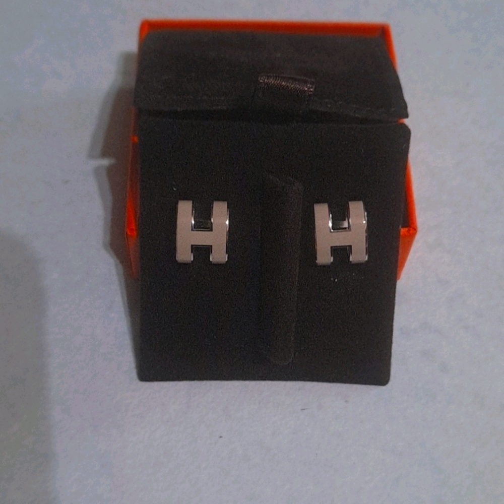 Hermes stud earrings,  cream color logo